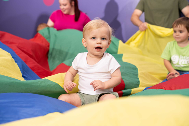 exercise with infant colorful parachute