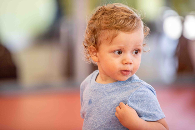 A little boy is looking around