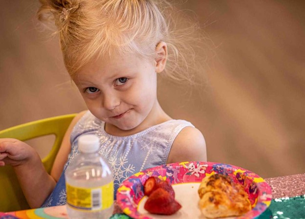 A child enjoying birthday snacks at the Little Gym